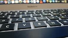 Detailed view of a MacBook Air keyboard with focus on keys, emphasizing technology and design.